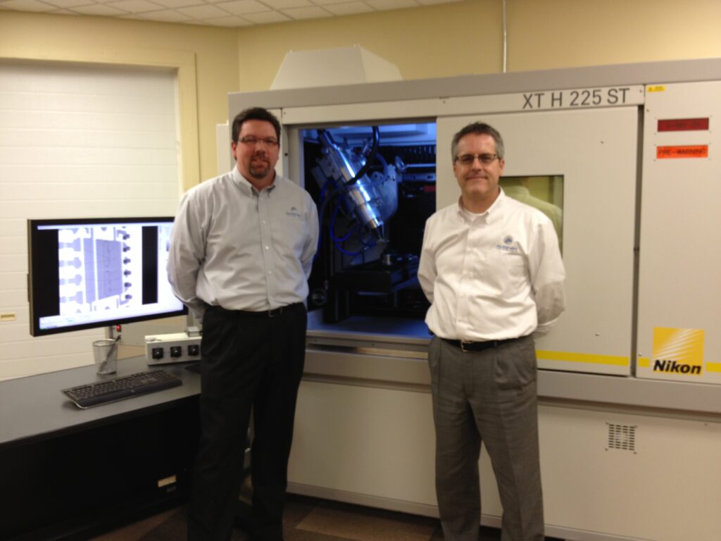 Jeff and Brian standing in front of their scan machine